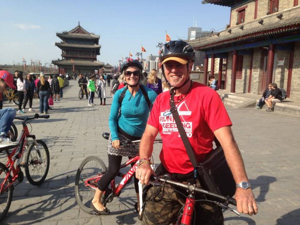 Two travelers with bicycles on a historic city wall