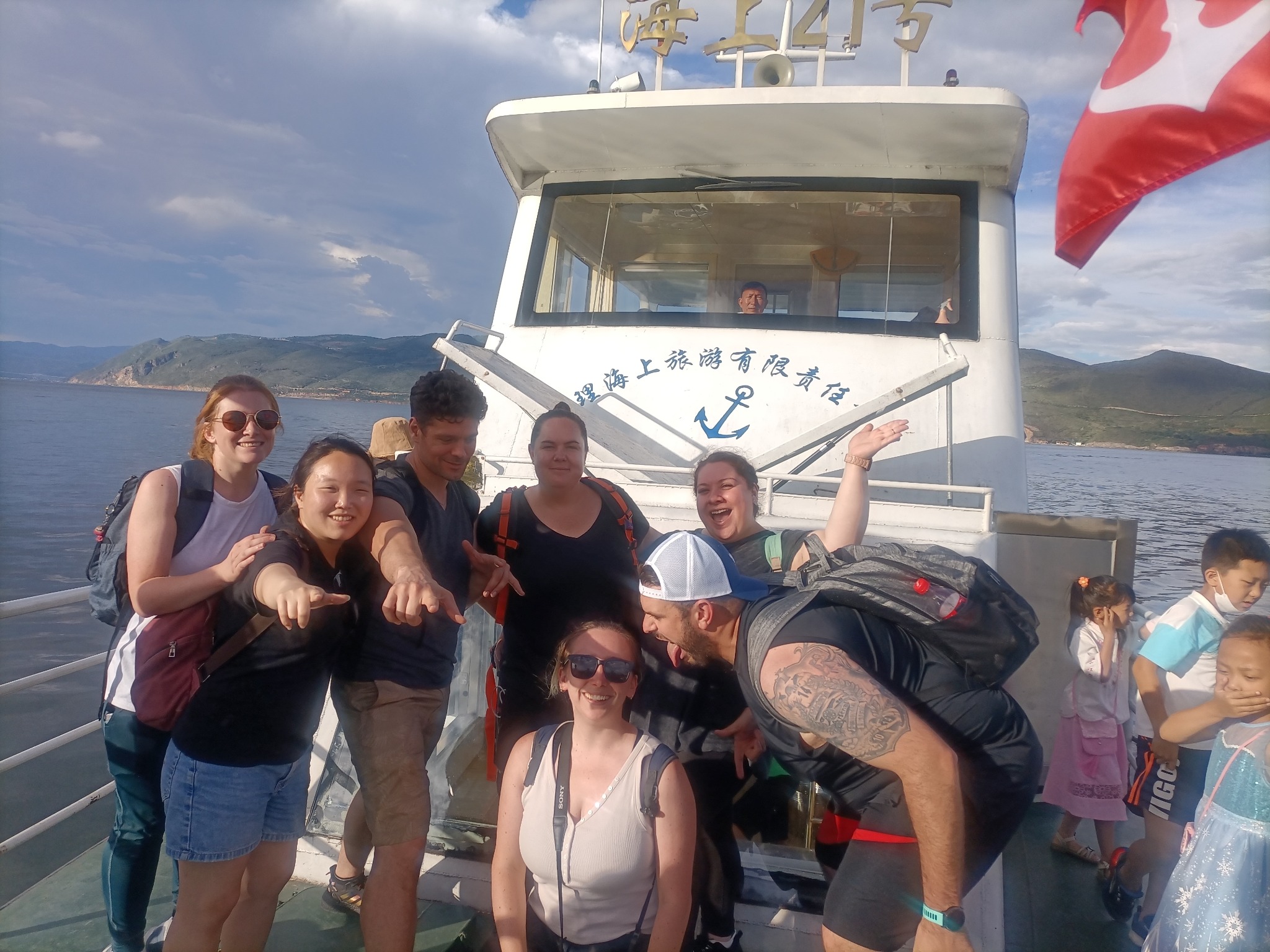 Travelers posing together aboard a boat